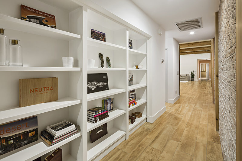 A secret door in this built-in white bookcase leads to a hidden bedroom.