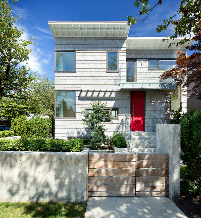 13 Examples Of Modern Houses With Wooden Shingles // This corner house in Vancouver, covered in light grey shingles.