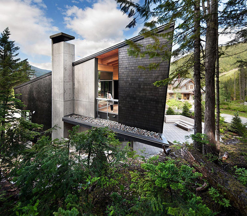 13 Examples Of Modern Houses With Wooden Shingles // Black shingles on the side of this Whistler property, contrast the natural wood and concrete throughout the rest of the house.