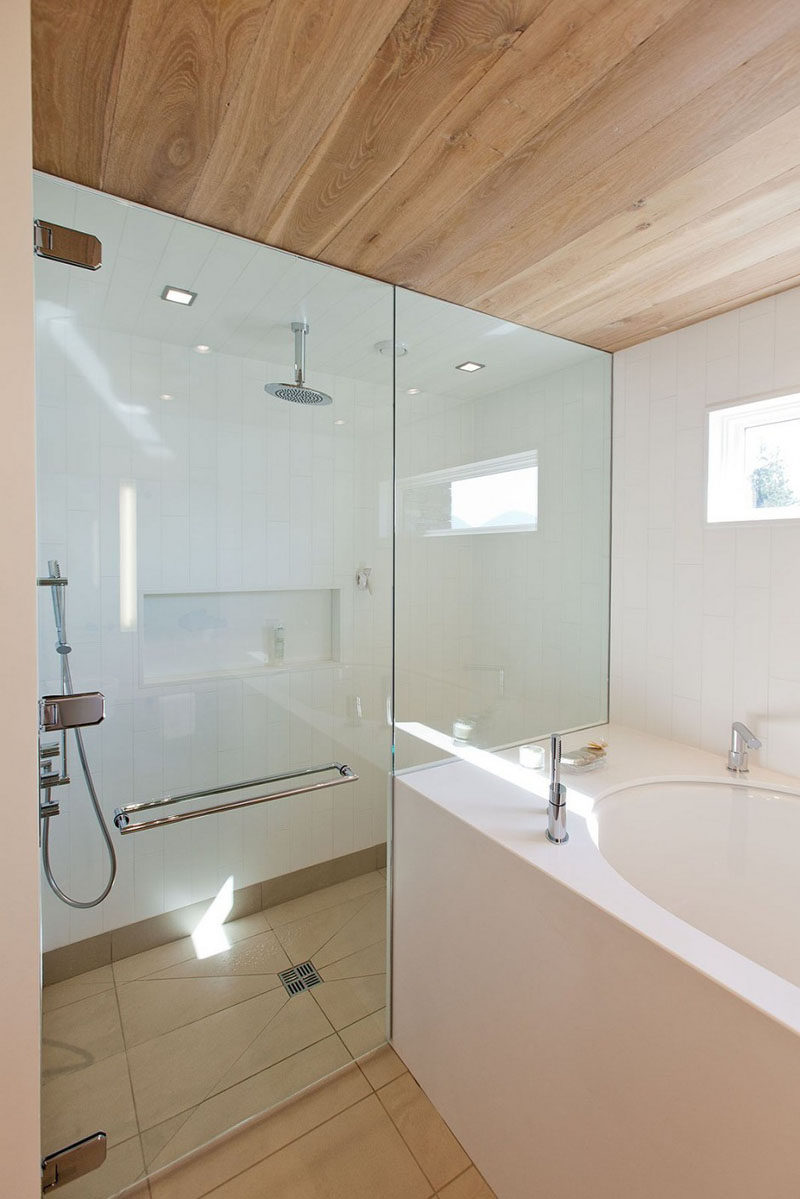 12 Ideas For Including Built-In Shelving In Your Shower // The shelf in this shower blends right in with the white tiles.