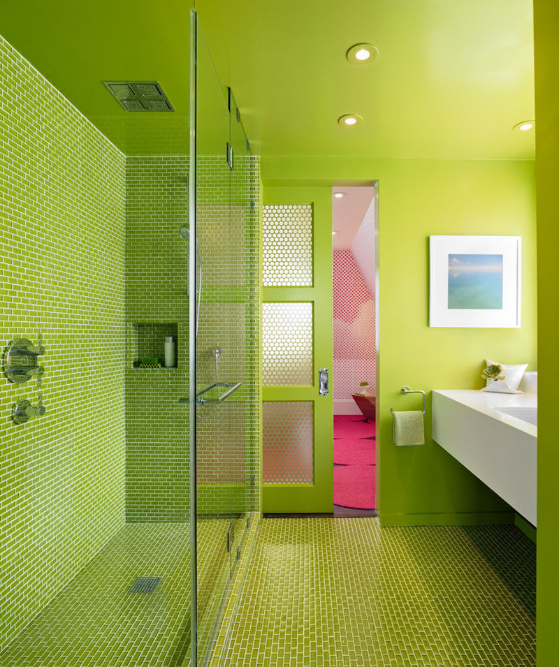 12 Ideas For Including Built-In Shelving In Your Shower // The built-in shelf in this all green bathroom is covered with the same tiles as the rest of the shower and bathroom floor.