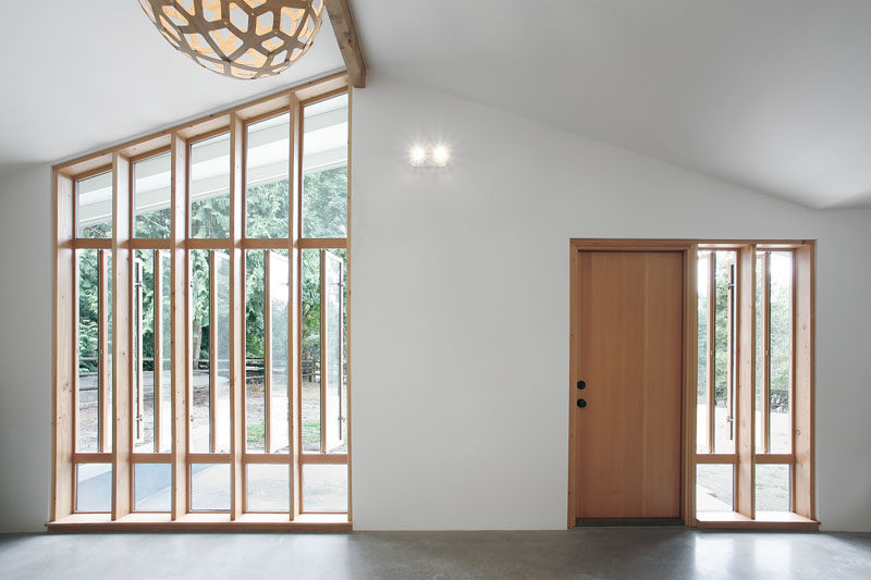 White walls, a pitched ceiling, touches of wood and concrete floors, make up the interior color palette in this guest house.