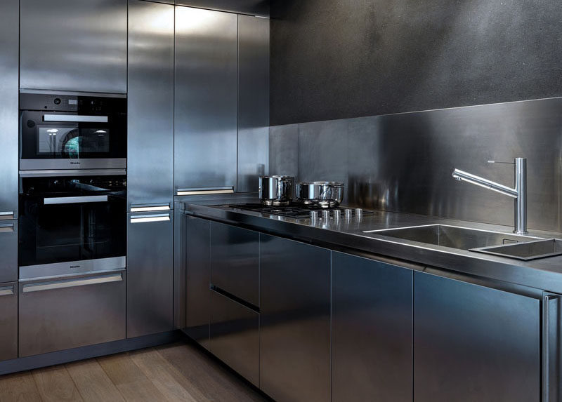 This stainless steel kitchen has appliances, faucet, sink, walls, counter tops, and cabinetry that are all stainless steel to give the kitchen a clean, futuristic look. to maintain the smooth look, hardware has been eliminated in favor of hidden pulls built right into the steel drawers and cabinets.