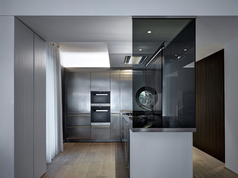 This stainless steel kitchen has appliances, faucet, sink, walls, counter tops, and cabinetry that are all stainless steel to give the kitchen a clean, futuristic look. to maintain the smooth look, hardware has been eliminated in favor of hidden pulls built right into the steel drawers and cabinets.