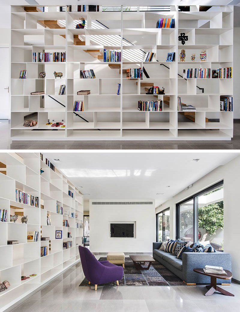 9 Stylish Staircases With Bookshelves As Safety Rails // The open shelving alongside this staircase lets light through and makes the stairs feel much more open.