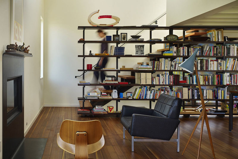 9 Stylish Staircases With Bookshelves As Safety Rails // This small house maximizes storage with a bookshelf on one side of the stairs.