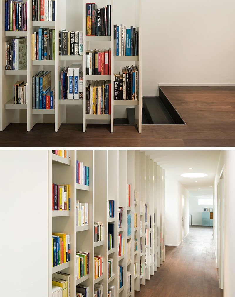 9 Stylish Staircases With Bookshelves As Safety Rails // This bookshelf acts as a safety barrier between the stairs and the corridor.