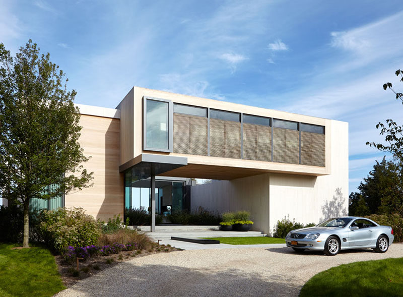 This home, located in North Haven, New York, has a central void that provides water views from the driveway, right through the house and into the backyard.