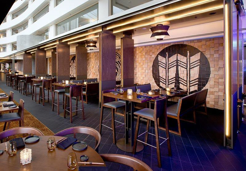 Wall Decor Idea - Murals On Painted Wood Blocks. The wood block wall in this restaurant is filled with Japanese-inspired murals, that have been painted in black.