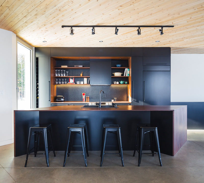 If you've got an island with space for seating, bar stools can bring in black in a stylish and functional way. #BlackBarStools #BlackSeating #BlackKitchen