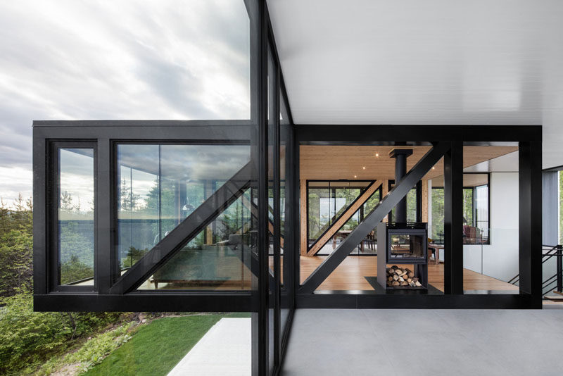 The home, designed by ACDF Architecture, has a bold black and glass box that overhangs above the garden below.