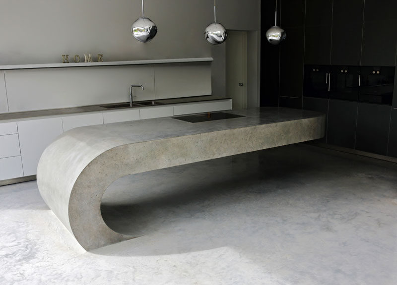 This cantilevered kitchen island is made from concrete.