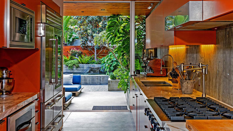 This kitchen with stainless steel appliances, opens up to a small patio area.