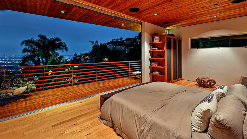 This bedroom has a wall that opens up to a private balcony with views of Hollywood.