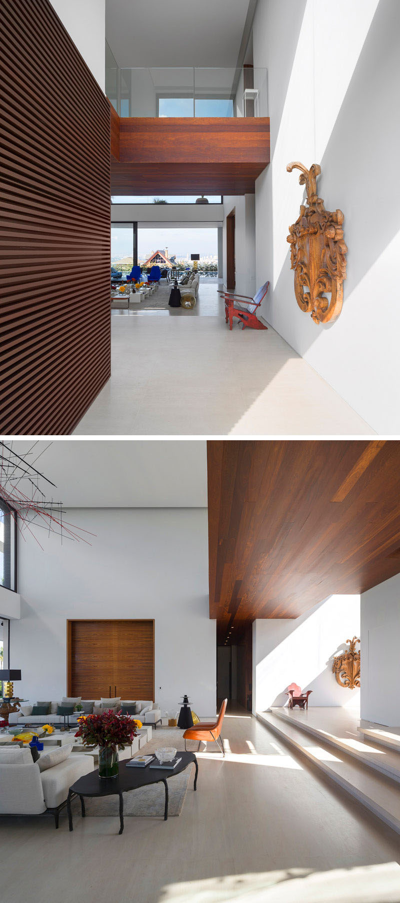 The entry way of this home reveals a double height ceiling, white walls and wood detailing.