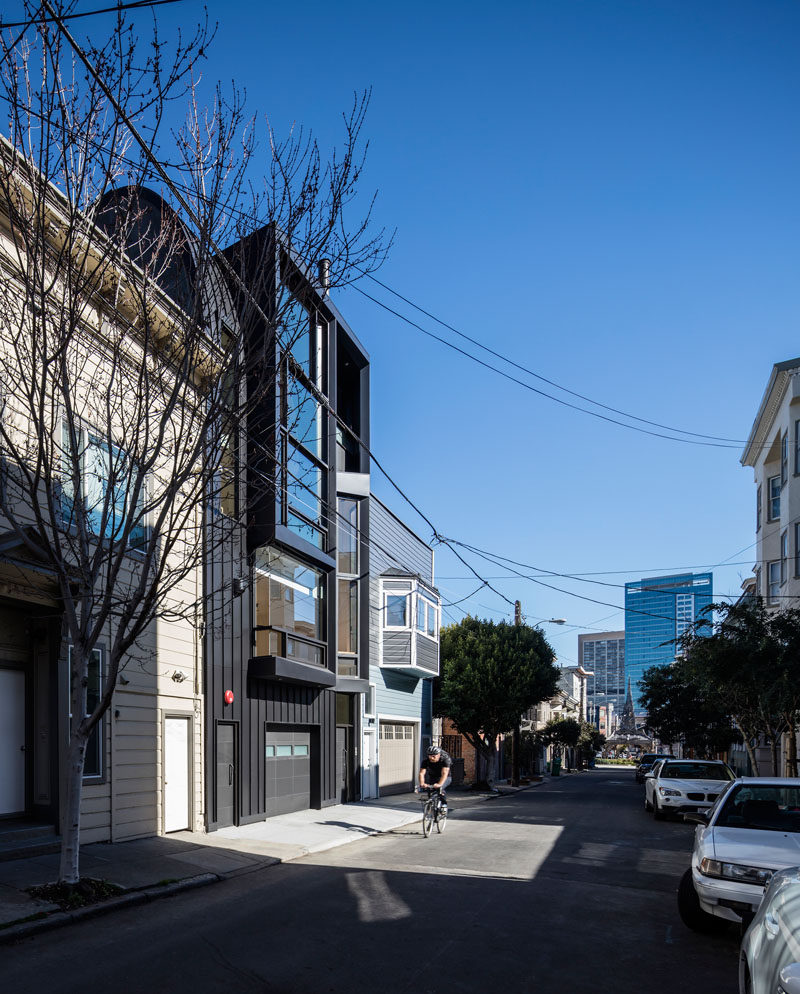 Designed by Stephen Phillips Architects, this black apartment building in San Francisco, is in a mixed-use commercial and residential district, that incorporates an eclectic group of traditional one- to four-story Victorian and Edwardian houses.