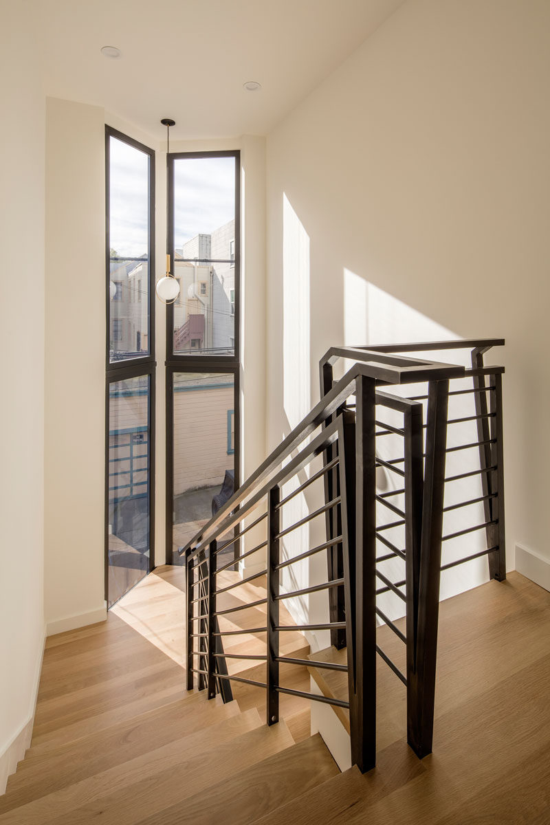 Bleached white oak flooring and black handrails give these stairs a contemporary look.