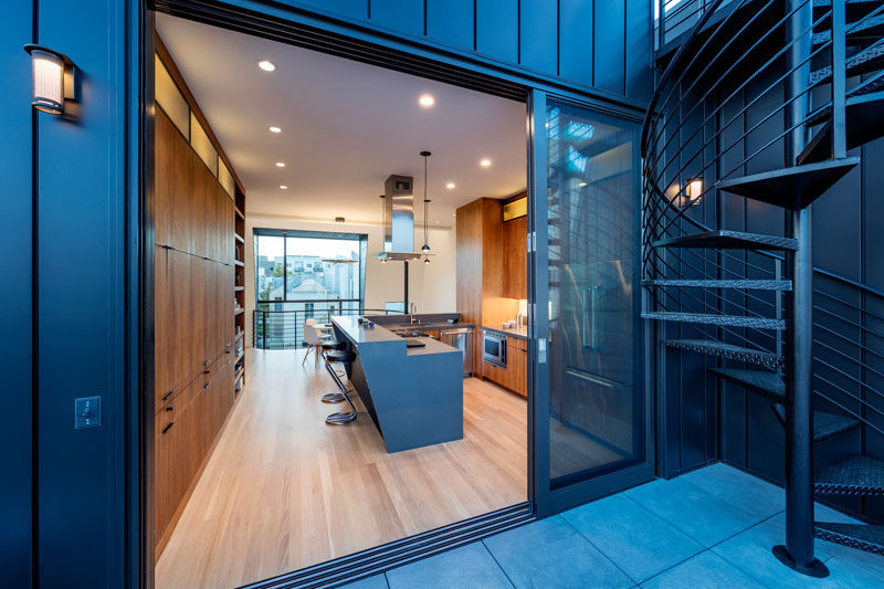 This warm wood kitchen opens up to the balcony outside.