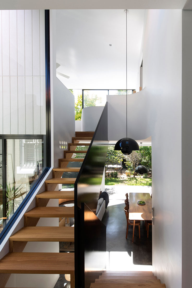 Black and wood see through stairs allow you to view the backyard as you walk up them.