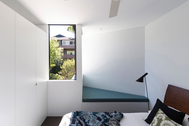 This bedroom has a small angled reading nook with views of the backyard.