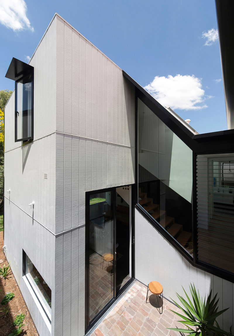 This home has a small patio with brick paving, that's tucked between the original house and the new extension.