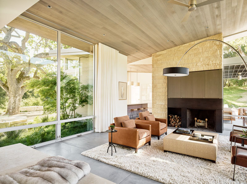 Large floor-to-ceiling windows contribute natural light to the living room, that is home to an interior palette of cedar-clad ceilings, oil-rubbed steel, and exposed concrete floors.