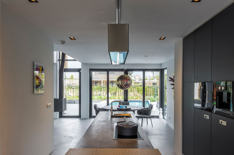 This kitchen and dining area are filled with natural light from the floor-to-ceiling windows.