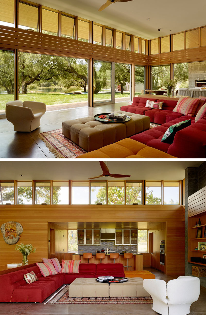 This living room, that opens to the backyard, is full of comfortable colorful sofas.