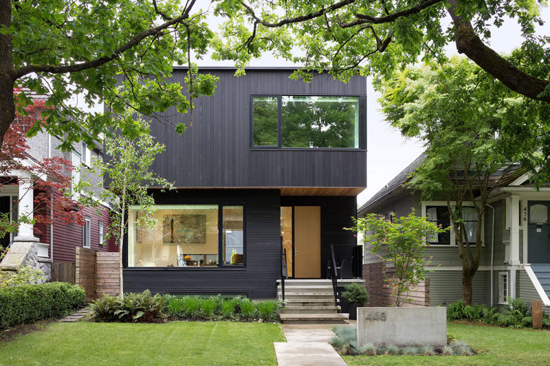 This black house in Vancouver, Canada, has some nice curb appeal with a fully landscaped front yard.