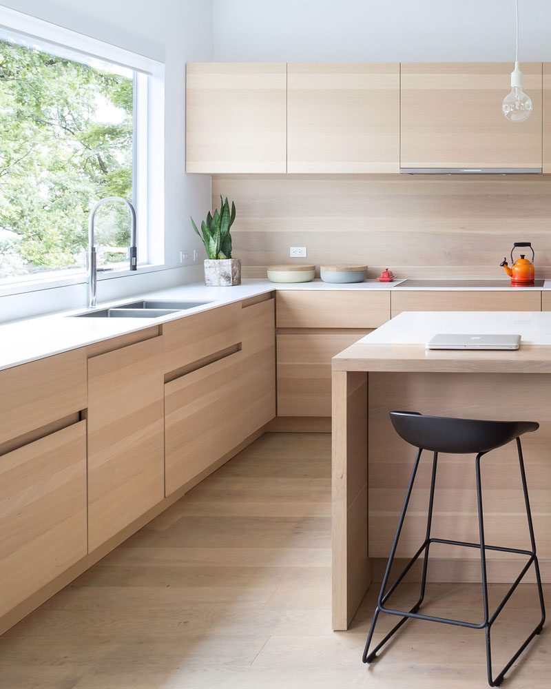 KITCHEN IDEA --- These light wood cabinets have finger pulls instead of hardware, making it more contemporary and streamlined.