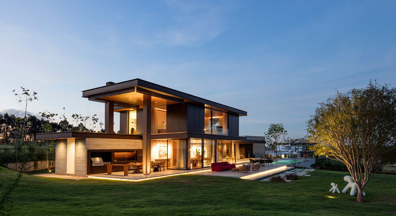 This contemporary farmhouse in São Paulo, Brazil, takes advantage of the views and outdoor lifestyle, with a large backyard, swimming pool, outdoor kitchen and dining area, as well as an outdoor lounge.