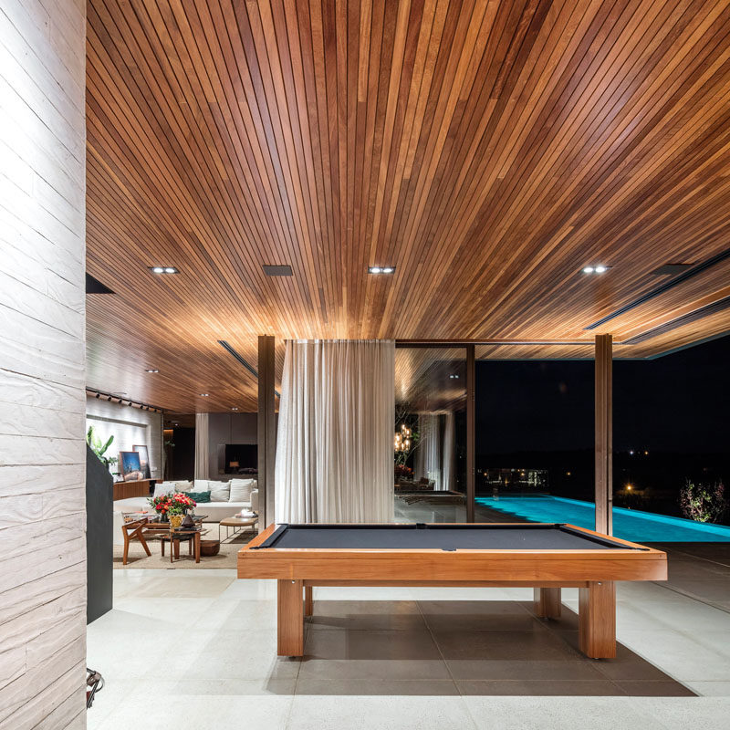 Around the corner from the living room in this home, is a dedicated spot for a pool table. Perfect for when you want to have a game after cooling off in the swimming pool.