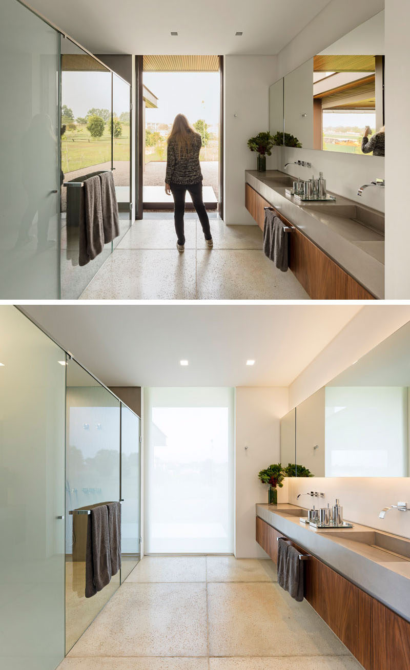 In this master bathroom, there's a dual sink vanity, and a floor-to-ceiling window, but don't worry it becomes frosted when needed for privacy.