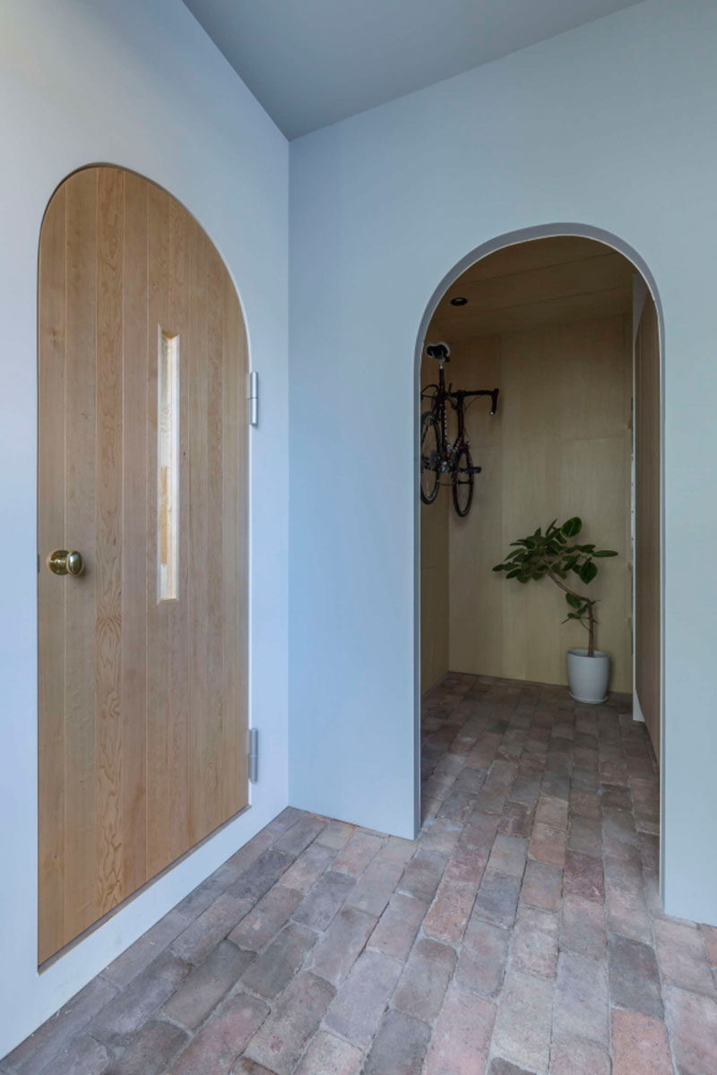 This Japanese home with wood and white interiors, is filled with arched doorways.