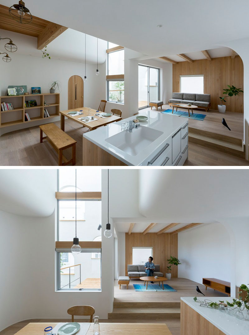 The kitchen and dining room of this home are located on the same level, with a small living room raised slightly to separate it from the rest of the space.