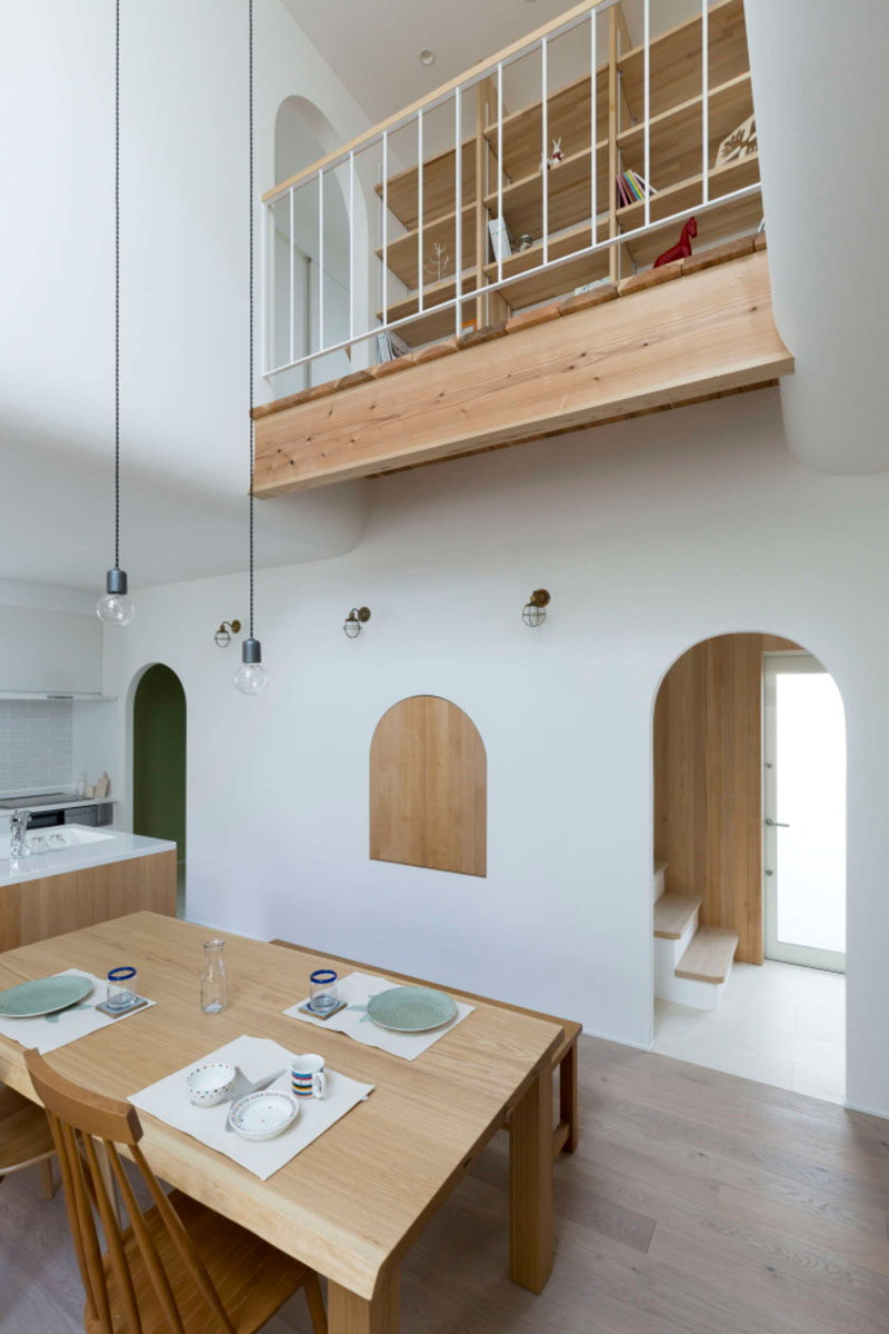 This Japanese home with wood and white interiors, is filled with arched doorways and details.