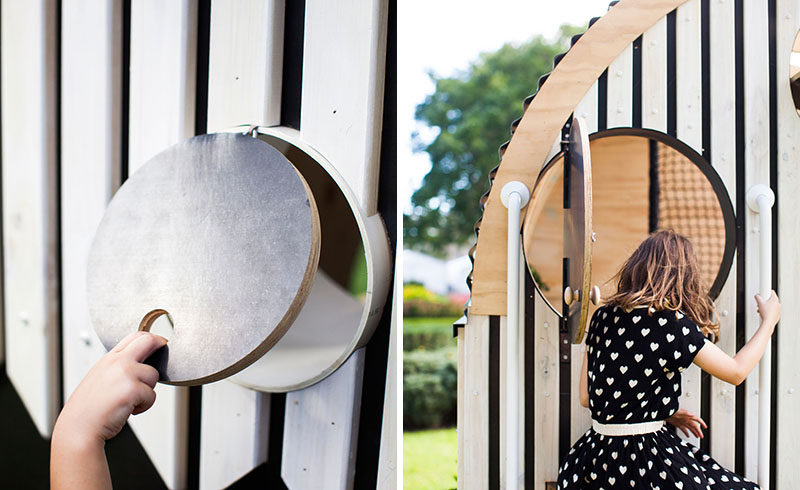 This modern playhouse (or cubbyhouse) has decorative siding and a curved roof with windows. Inside, there's bench seating, storage and loft with a net for relaxing.