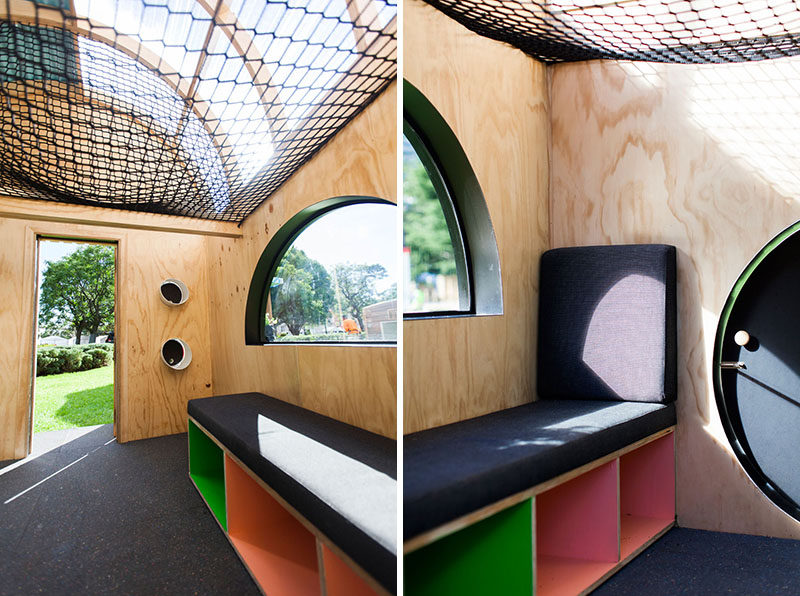 This modern playhouse (or cubbyhouse) has decorative siding and a curved roof with windows. Inside, there's bench seating, storage and loft with a net for relaxing.