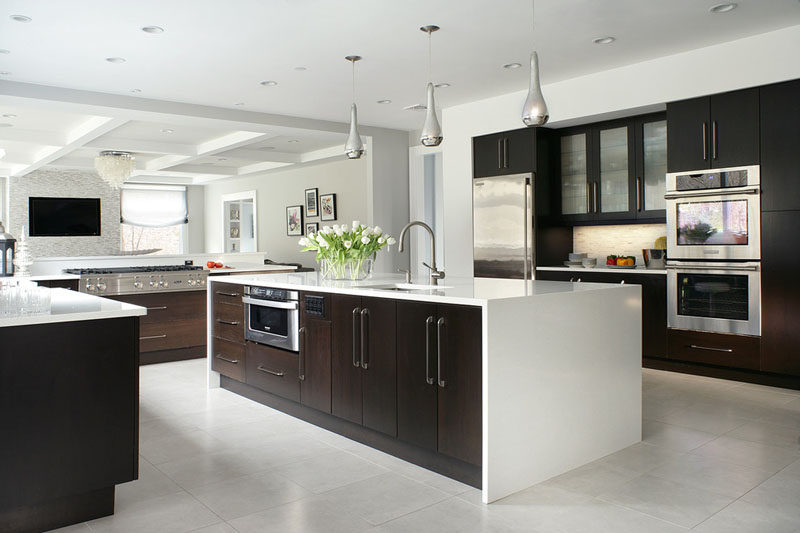 9 Inspirational Kitchens That Combine Dark Wood Cabinetry and White Countertops // The white countertop that wraps around the island of this kitchen keeps the dark wood from being over powering and helps create flow throughout the space.
