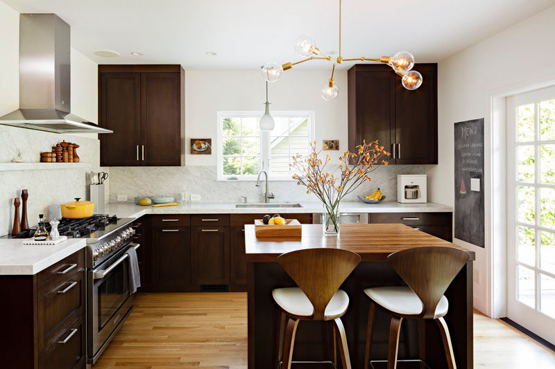 9 Inspirational Kitchens That Combine Dark Wood Cabinetry and White Countertops // The bright walls and the marble backsplash help this kitchen feel bright and open while the dark wood makes it feel cozy.