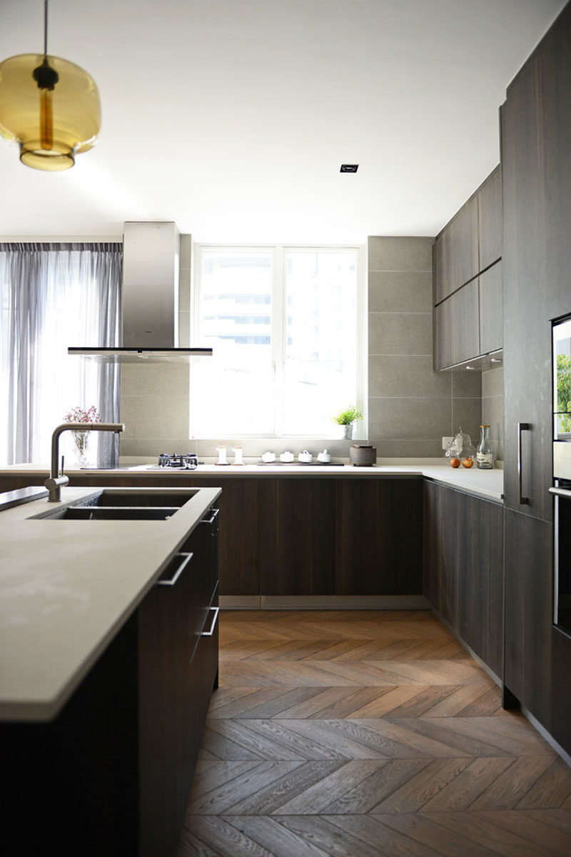 9 Inspirational Kitchens That Combine Dark Wood Cabinetry and White Countertops // The stainless steel, dark wood, and contrasting white countertop make this kitchen feel very contemporary.