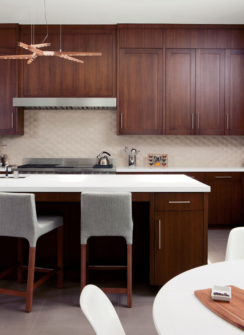 9 Inspirational Kitchens That Combine Dark Wood Cabinetry and White Countertops // The copper light fixture brings out the copper tones in the wood used in this L.A. home, designed by Mike Jacobs Architecture.