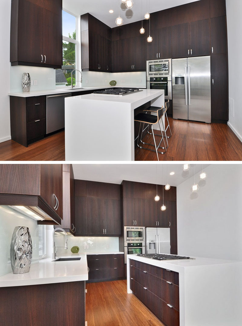 9 Inspirational Kitchens That Combine Dark Wood Cabinetry and White Countertops // Super dark cabinetry, white countertops, and stainless steel appliances make this kitchen dramatic and modern.