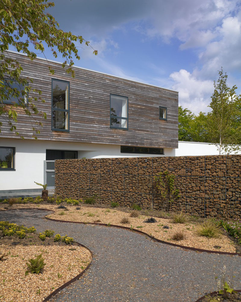 A gabion is a cage filled with rocks, concrete scraps, or really anything you can fit into the wire cage. #Gabion #LandscapingIdeas #FenceIdeas #ModernFence #Architecture #Landscaping