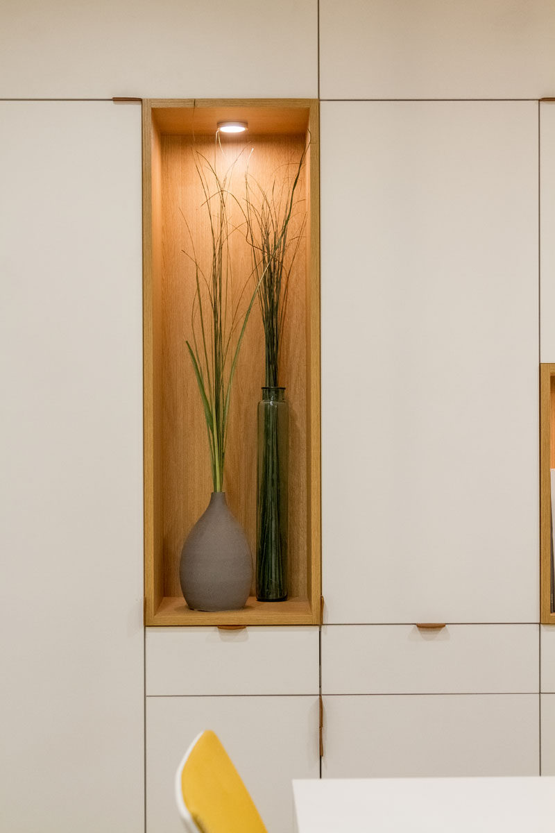 A close-up look at an open shelf positioned within cabinetry, perfect for displaying vases and artwork.