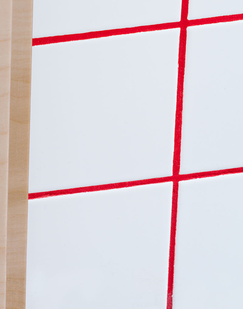 Bright red grout between white tiles was used to brighten up this bathroom.