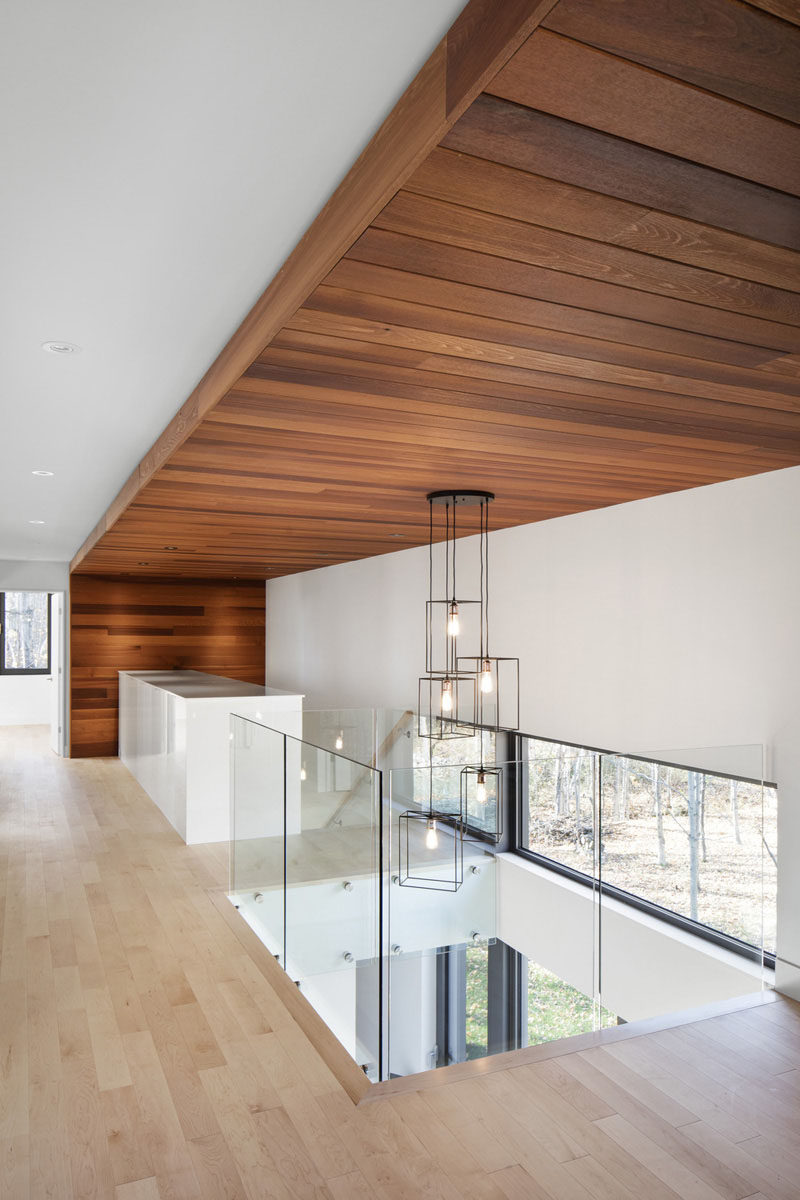 As you head upstairs in this home, you’re greeted by large cedar wood slats that wrap from the floor to the ceiling, and back down to the floor.