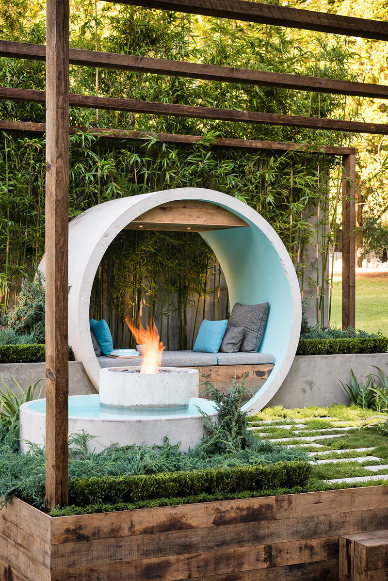 This landscaping idea uses a number of concrete pipes to created a meditation moon gate / day bed, a reflective water feature, and a fire pit.