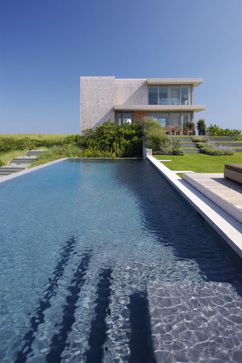 This house in Bridgehampton, New York, has a swimming pool surrounded by a peaceful landscape.