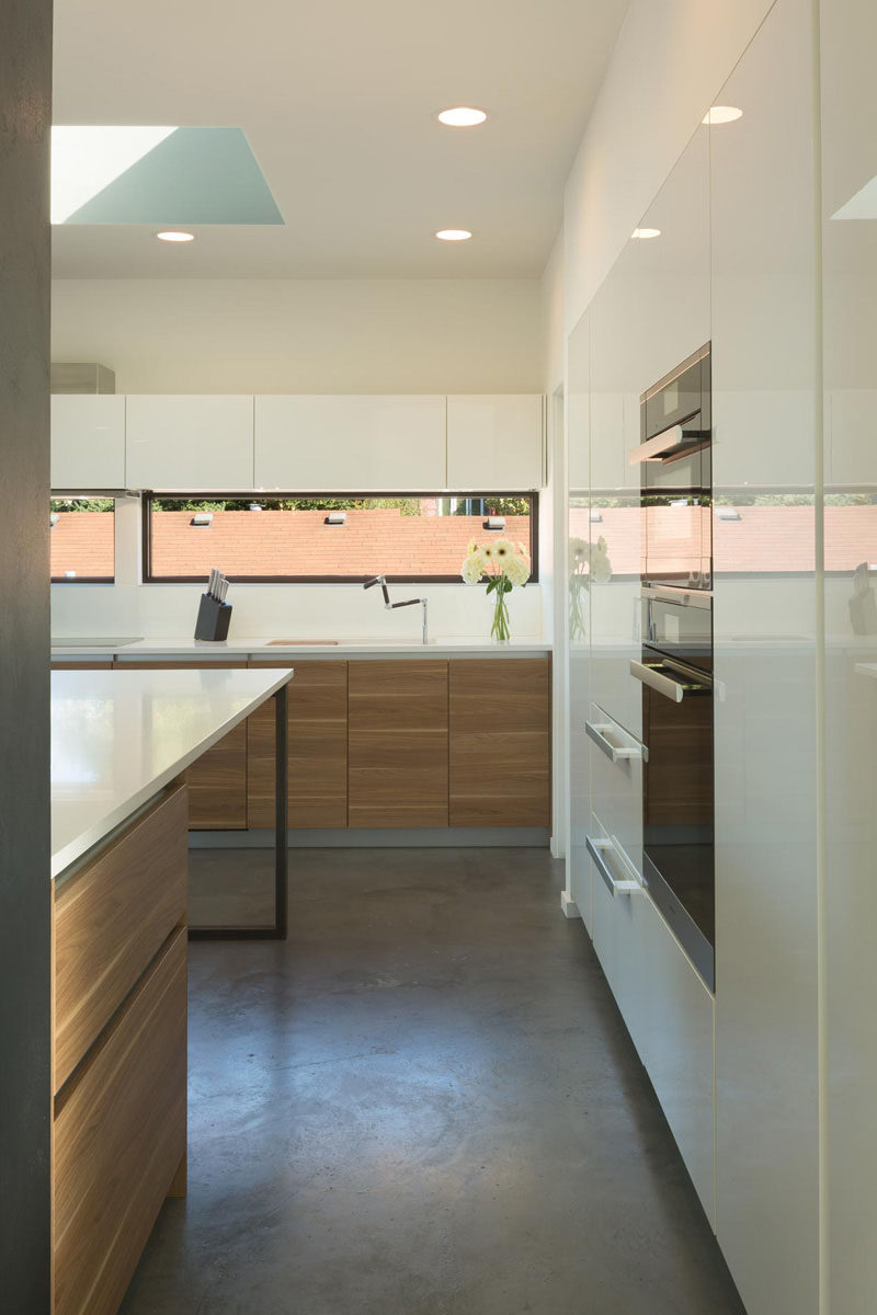 12 Inspirational Examples Of Letterbox Windows In Kitchens // The horizontal letterbox windows in this Seattle home brighten the space, and because they're at roof level of the houses around them, allow the kitchen to be kept somewhat private from the rest of the neighborhood.